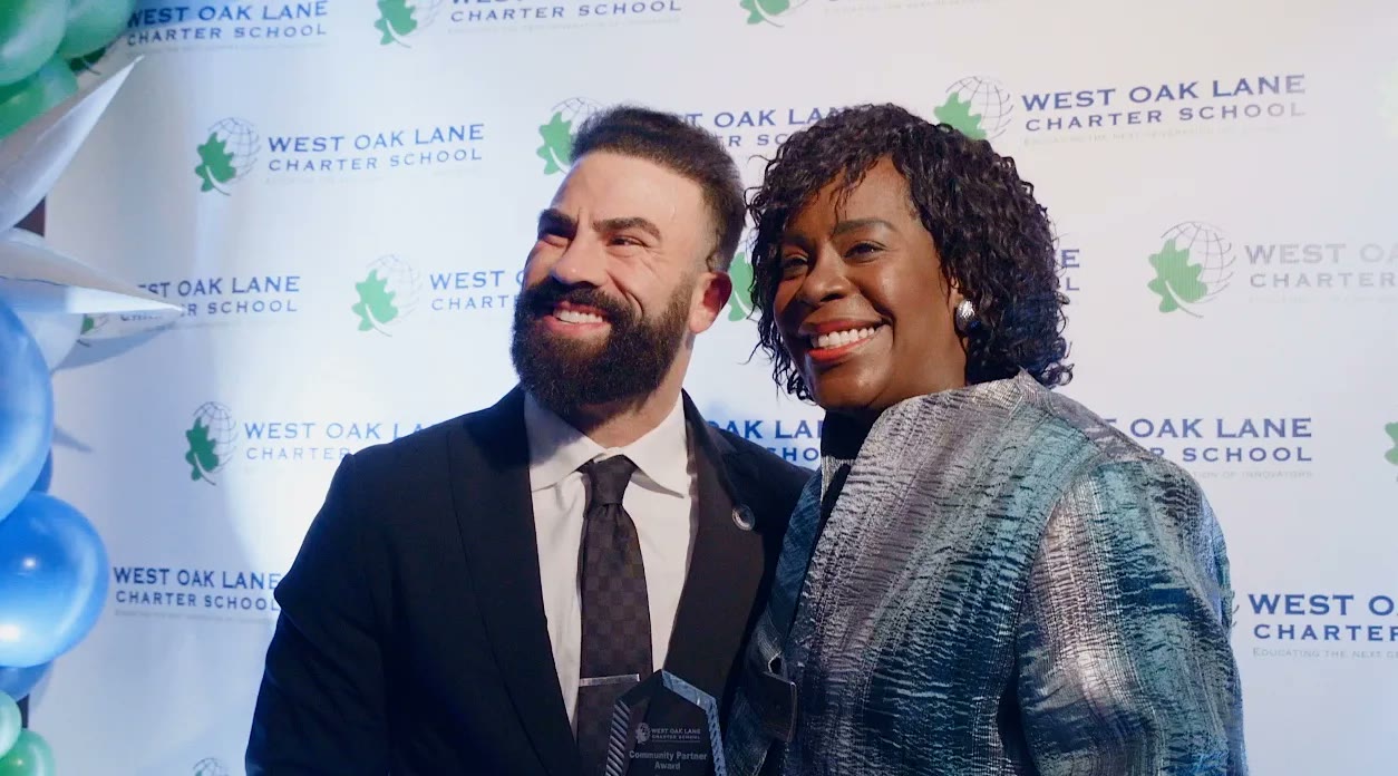 Matthew Laken accepting the Community Partner Award at West Oak Lane Charter School